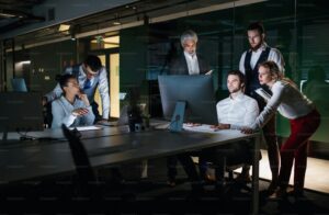 Students and young professionals working together in a bright coworking space St Louis, with modern desks, lamps, and large windows creating a collaborative atmosphere.