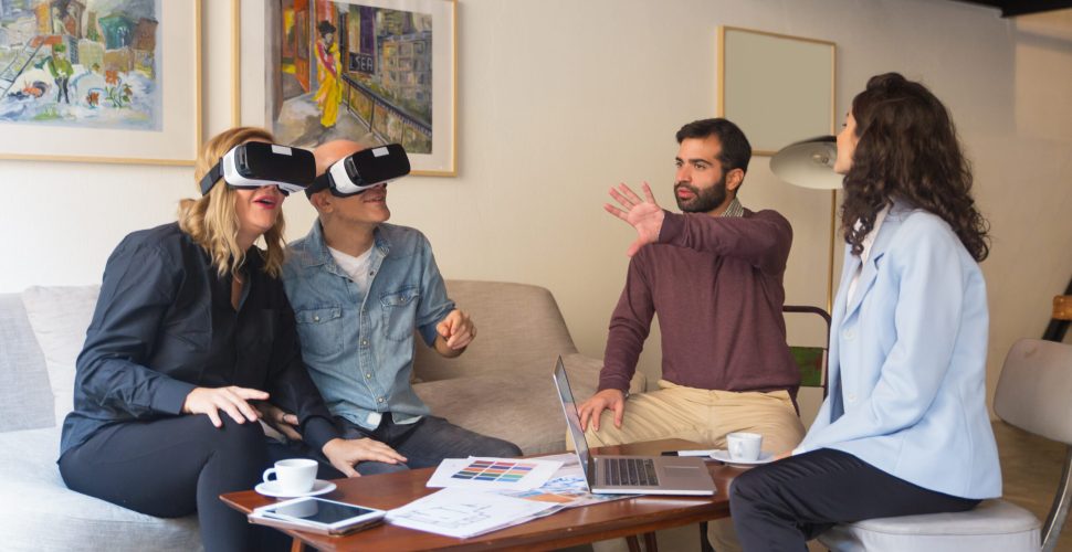 Middle aged customers enjoying VR experience in interior designer office. People using virtual reality technology at home. VR design project concept